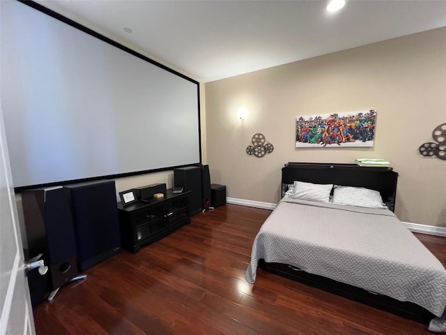 bedroom with dark hardwood / wood-style flooring