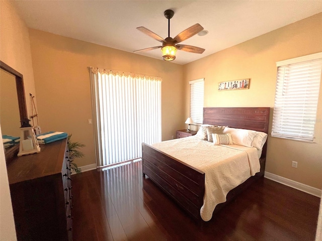 bedroom with multiple windows, lofted ceiling, dark wood-type flooring, and ceiling fan