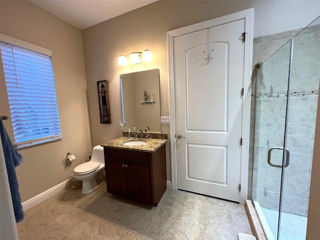 bathroom with an enclosed shower, vanity, and toilet