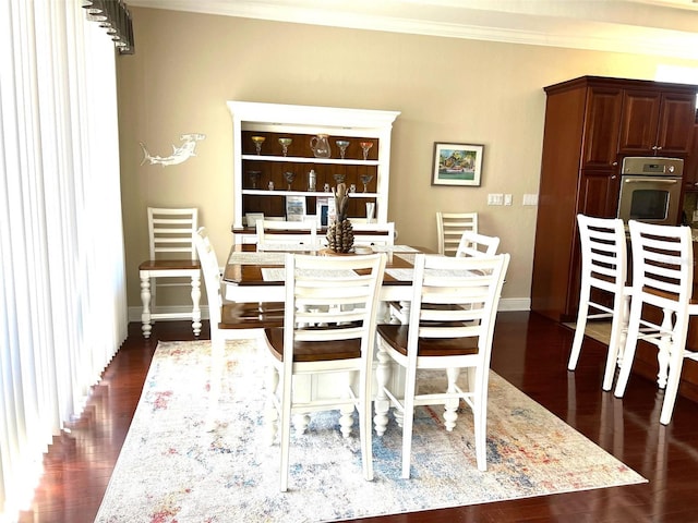 dining room with crown molding and dark hardwood / wood-style floors