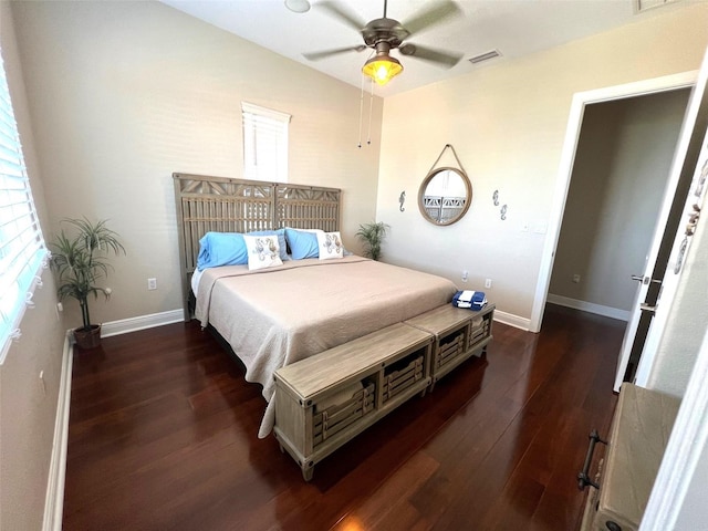 bedroom featuring dark hardwood / wood-style flooring, lofted ceiling, and ceiling fan