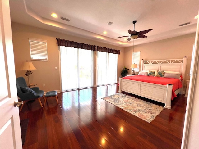 bedroom featuring a tray ceiling and dark hardwood / wood-style floors