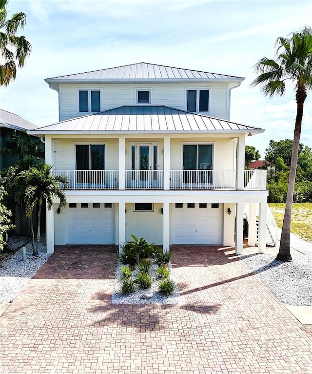 1421 Apollo Beach Blvd, Apollo Beach, FL 33572 - beach home featuring decorative driveway, a standing seam roof, stairs, and a garage