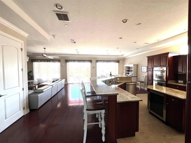 1421 Apollo Beach Blvd, Apollo Beach, FL 33572 - kitchen with visible vents, a healthy amount of sunlight, appliances with stainless steel finishes, and a large island with sink