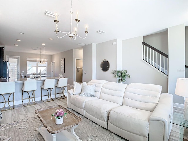 living room with a chandelier and light hardwood / wood-style flooring