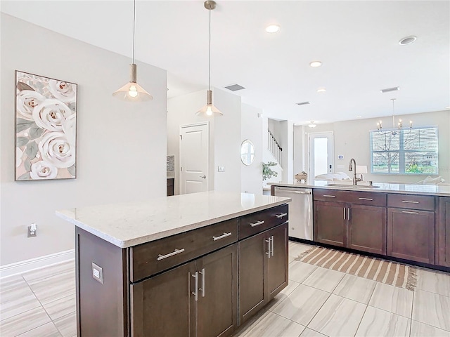 kitchen with sink, dishwasher, a center island, dark brown cabinetry, and decorative light fixtures