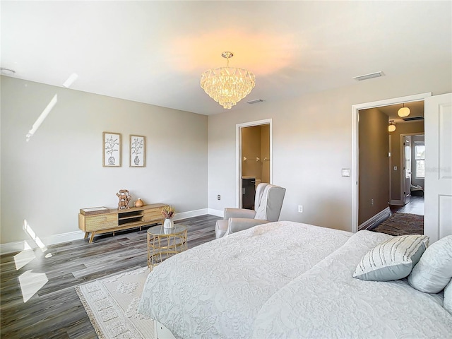 bedroom with wood-type flooring and a chandelier