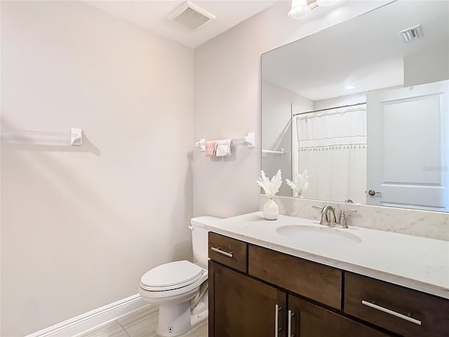 bathroom featuring vanity, toilet, and a shower with shower curtain