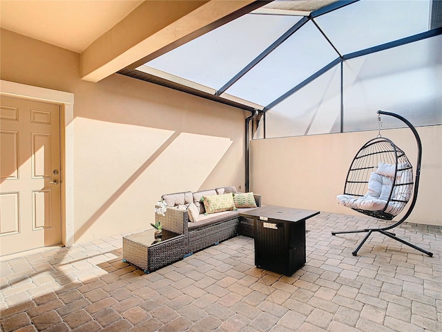 view of patio with an outdoor living space and a lanai