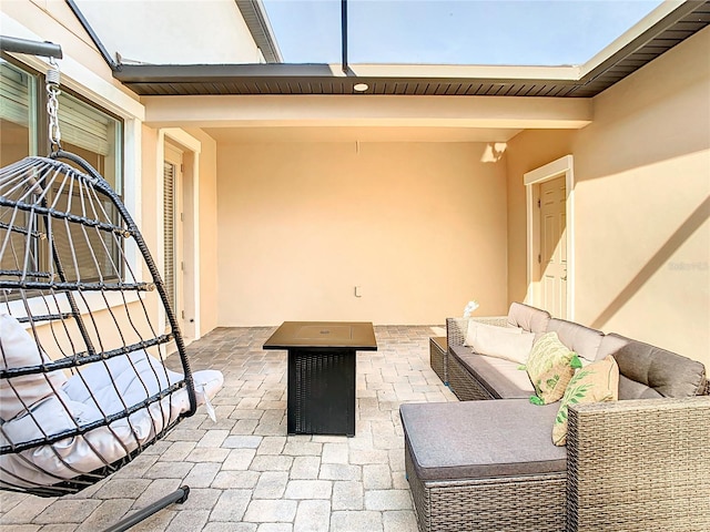 view of patio featuring an outdoor living space with a fire pit