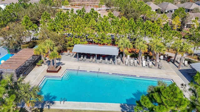 view of swimming pool with a bar and a patio