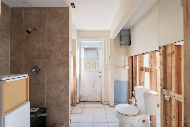 bathroom featuring tile walls, tile patterned floors, toilet, and walk in shower