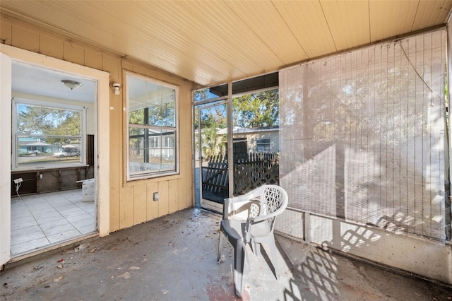 unfurnished sunroom with wood ceiling