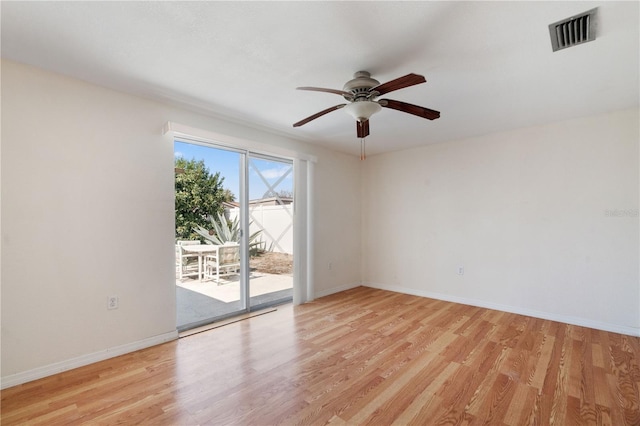 spare room with ceiling fan and light wood-type flooring