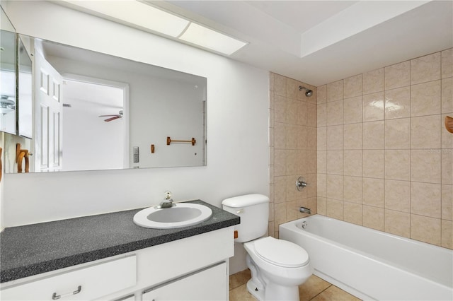 full bathroom featuring vanity, tile patterned flooring, tiled shower / bath combo, and toilet