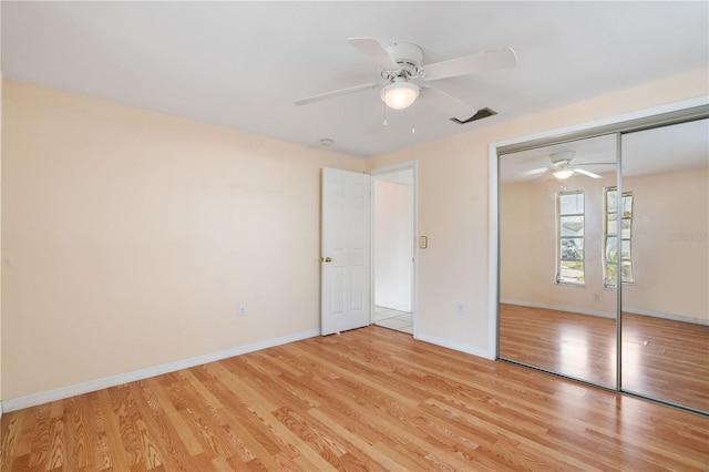 unfurnished bedroom featuring a closet, ceiling fan, and light hardwood / wood-style flooring