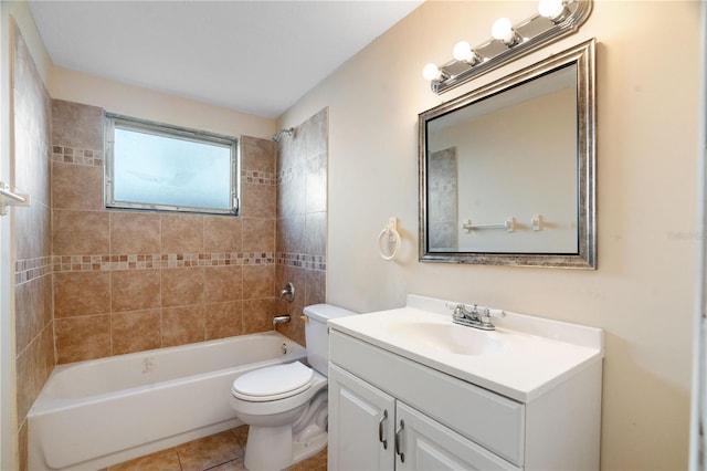 full bathroom featuring vanity, tiled shower / bath, tile patterned floors, and toilet