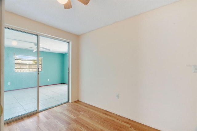 spare room featuring light hardwood / wood-style flooring and ceiling fan