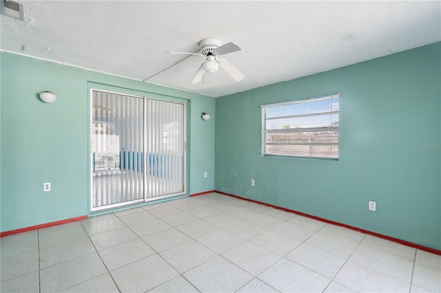 empty room with a textured ceiling and ceiling fan