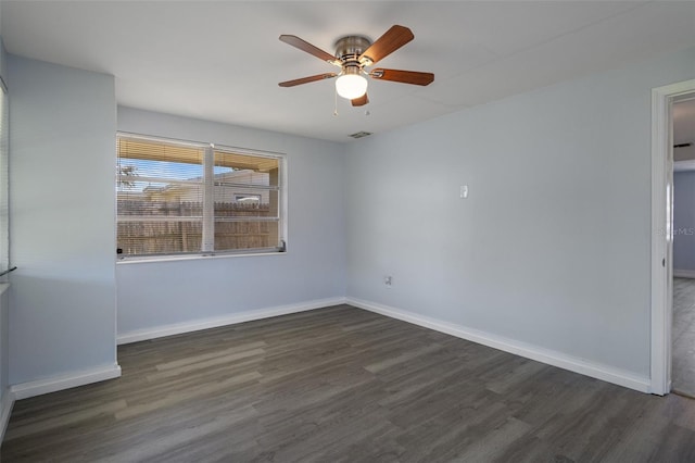 unfurnished room with ceiling fan, dark wood-type flooring, visible vents, and baseboards