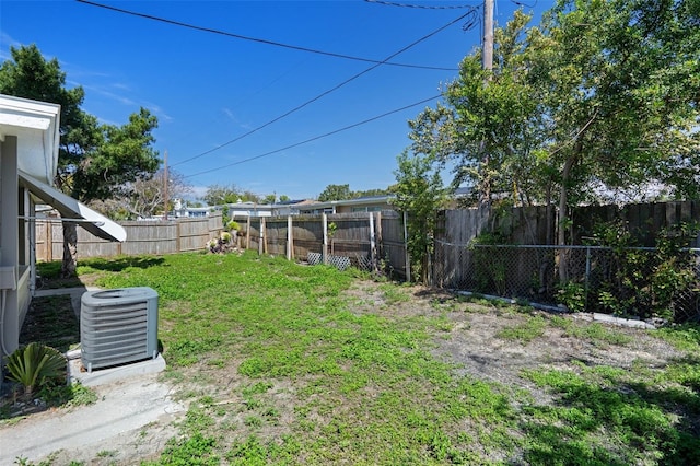 view of yard with a fenced backyard and cooling unit