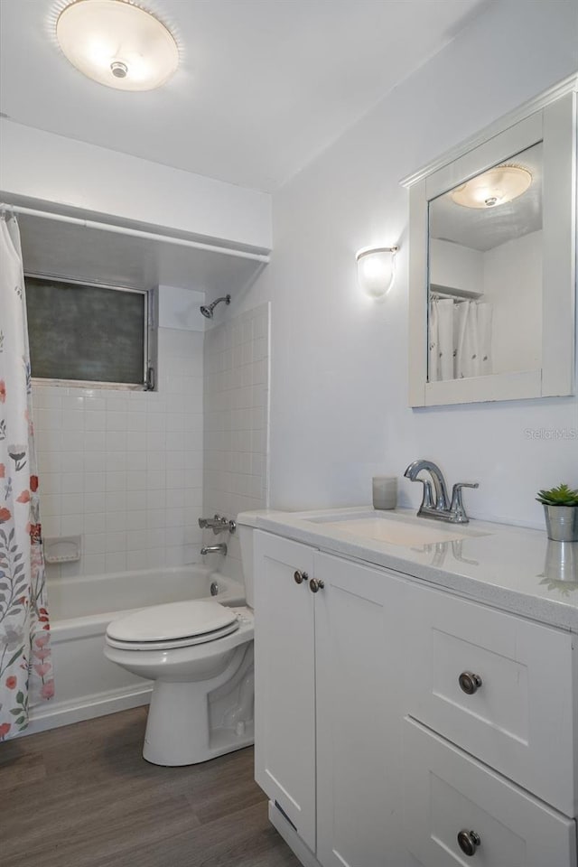 full bath featuring toilet, shower / bath combination with curtain, wood finished floors, and vanity