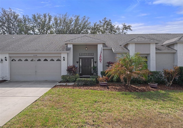 ranch-style house with a garage and a front lawn