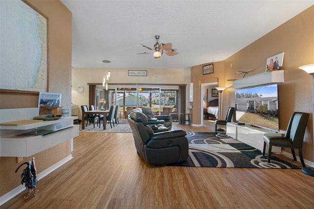 living room featuring hardwood / wood-style flooring and ceiling fan