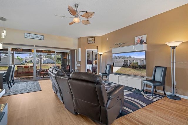 living room with ceiling fan and light hardwood / wood-style floors