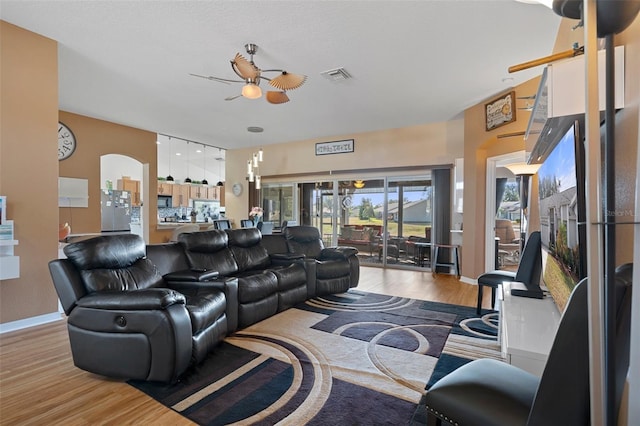 living room with light wood-type flooring and ceiling fan