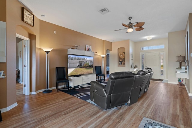 living room with ceiling fan and light wood-type flooring