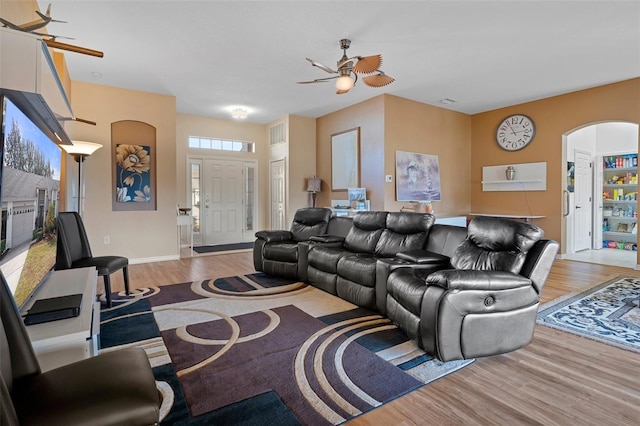 living room featuring light hardwood / wood-style floors and ceiling fan