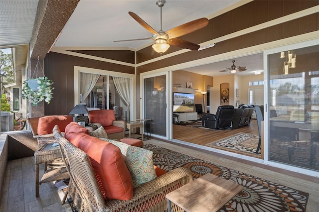 sunroom / solarium featuring ceiling fan and vaulted ceiling