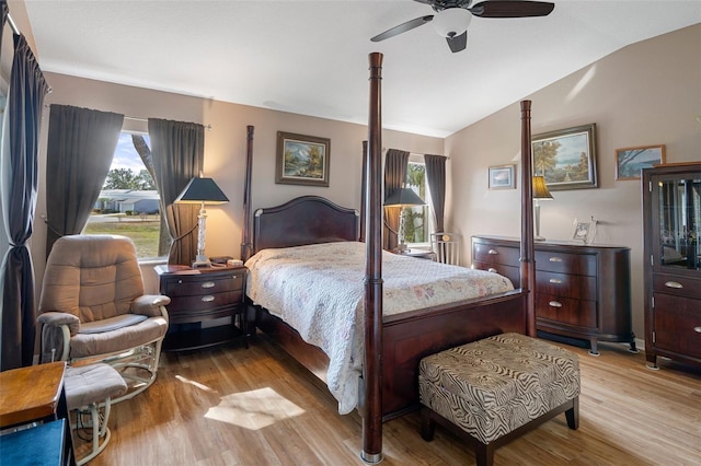 bedroom with lofted ceiling, light hardwood / wood-style flooring, and ceiling fan