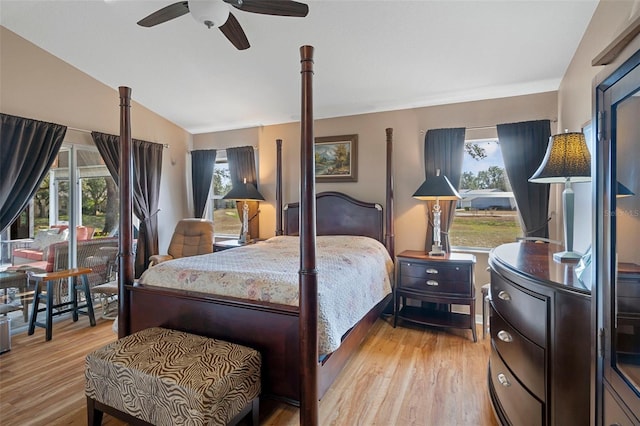 bedroom with lofted ceiling, ceiling fan, and light wood-type flooring