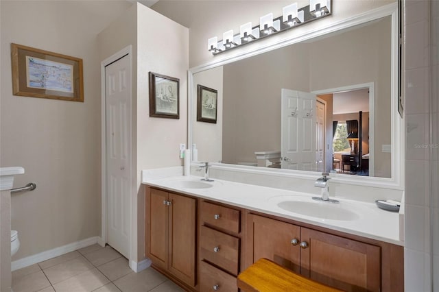 bathroom featuring tile patterned floors, toilet, and vanity