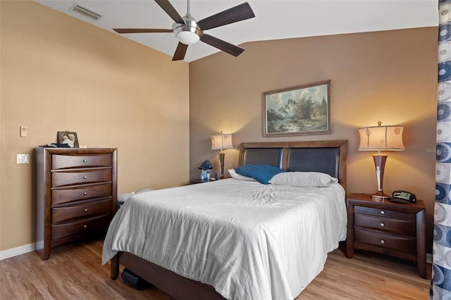 bedroom with vaulted ceiling, ceiling fan, and light wood-type flooring