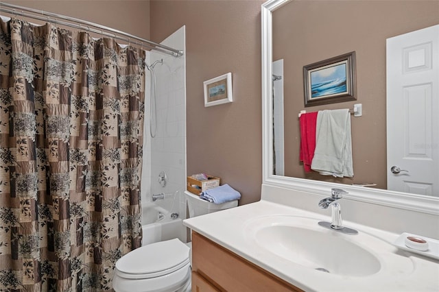 full bathroom with vanity, shower / tub combo, and toilet