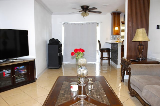 living room with ornamental molding, ceiling fan, and light tile patterned flooring