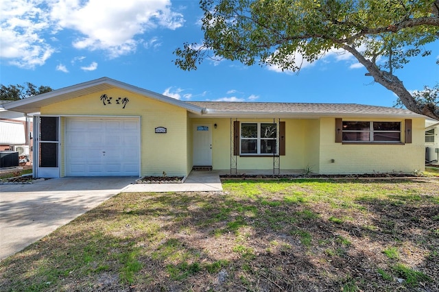 ranch-style house with a garage and a front lawn