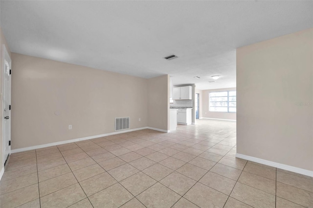 spare room featuring light tile patterned floors