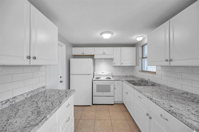 kitchen with backsplash, white appliances, sink, and white cabinets