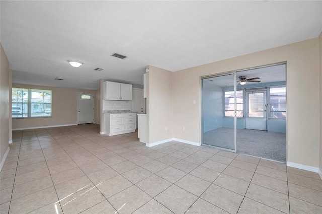 unfurnished living room featuring light tile patterned floors