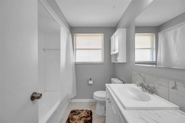 full bathroom with vanity, shower / bath combo, and toilet