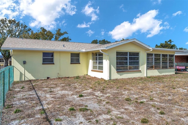 rear view of property with a sunroom