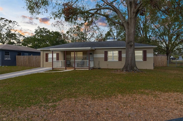 single story home with a yard and a porch