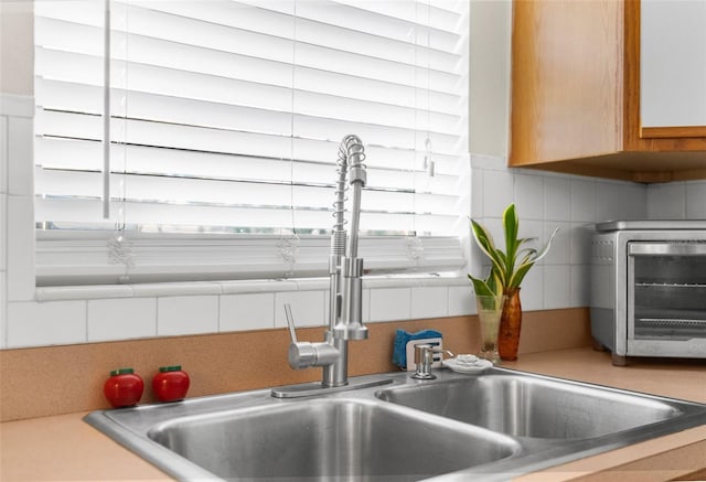 interior details with sink and decorative backsplash