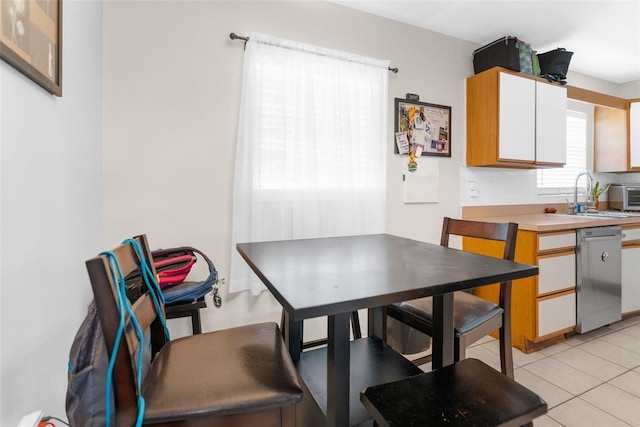 tiled dining area featuring sink