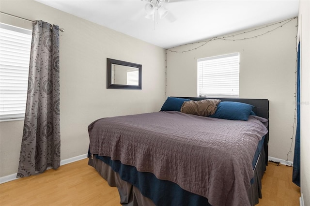 bedroom with ceiling fan and light hardwood / wood-style floors