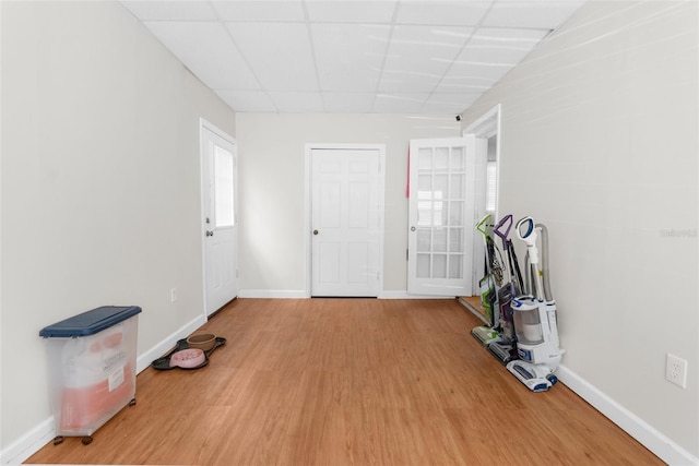 interior space featuring hardwood / wood-style flooring and a paneled ceiling